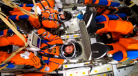 The Artemis II crew inside the capsule.