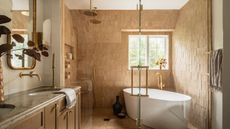 caramel brown bathroom with double shower and bathtub