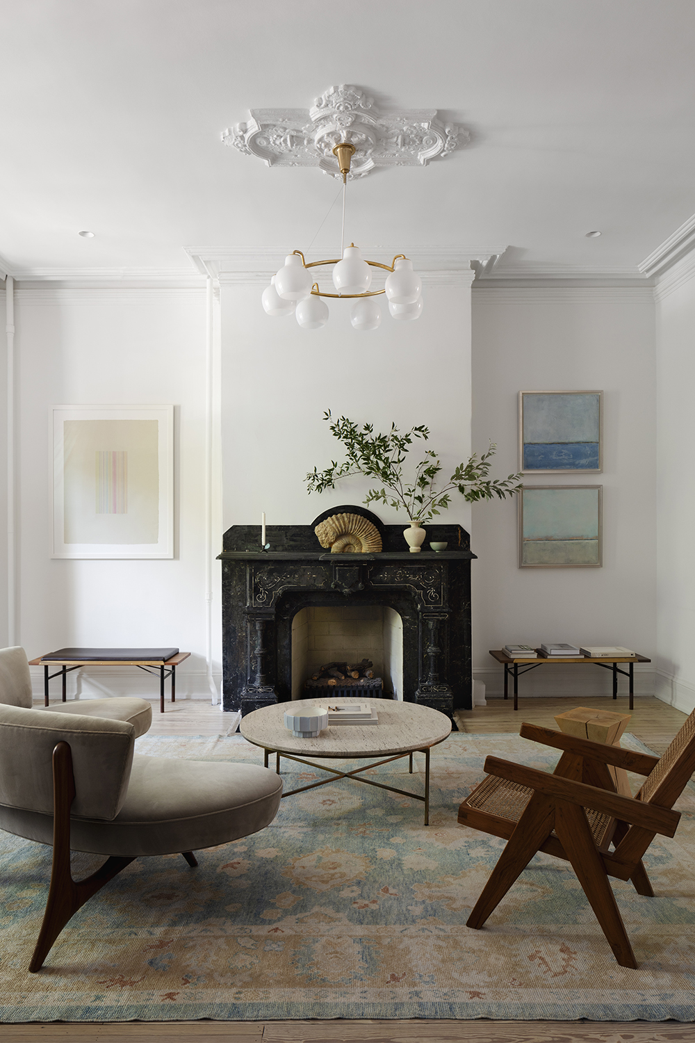transitional style living room with brown furniture and blue art