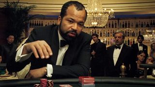 Jeffrey Wright plays cards while Giancarlo Giannini watches in the crowd in Casino Royale.