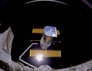 The Hubble Space Telescope is deployed from NASA's space shuttle Discovery on April 25, 1990.