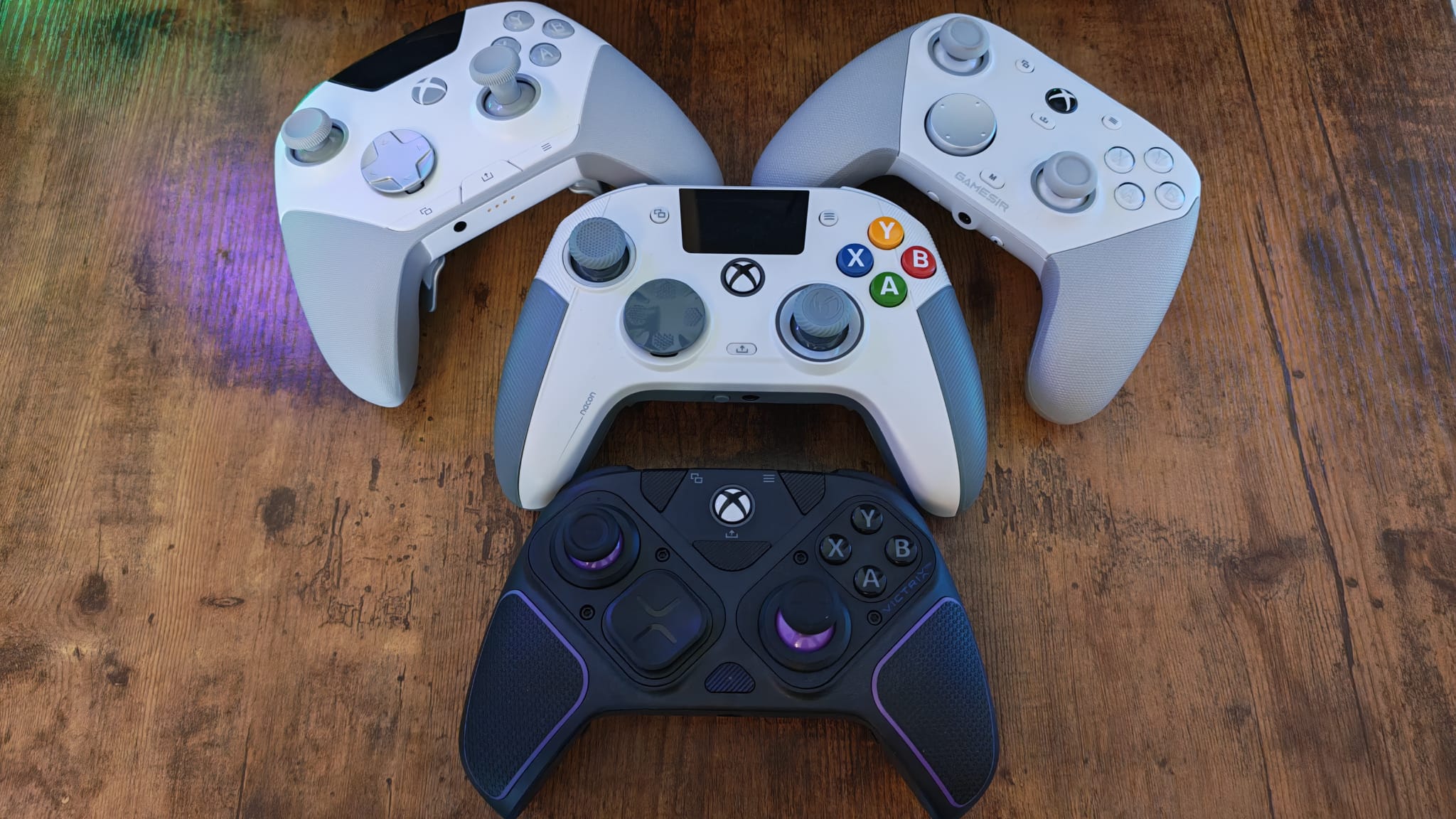 Four Xbox Series x controllers laid out on a desktop