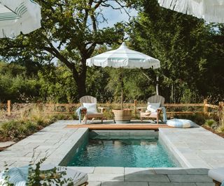 pool area with seats and umbrellas