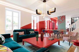 a living dining room with red painted walls