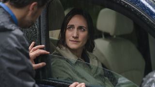 Cara Horgan as Becks sits in a car with wet hair in The Marlow Murder Club