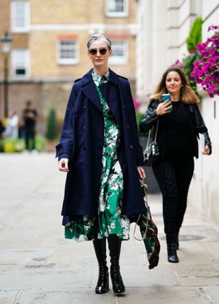 Woman with shirt grey hair in a long emerald dress