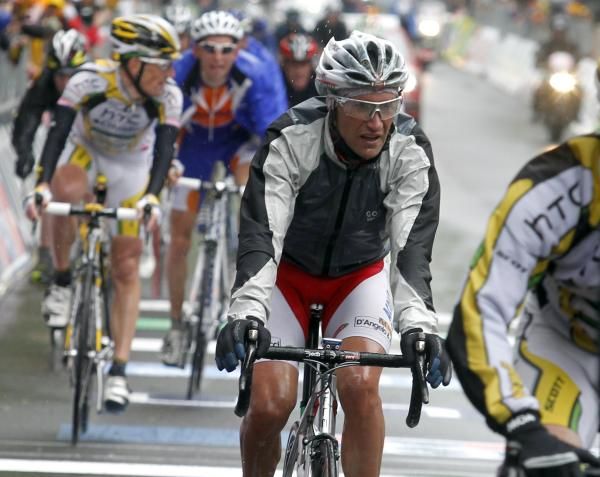 A soaked Stefano Garzelli (Aqua &amp; Sapone) crosses the line