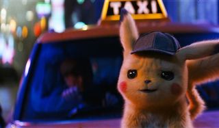 Detective Pikachu standing on a taxi's hood, smirking