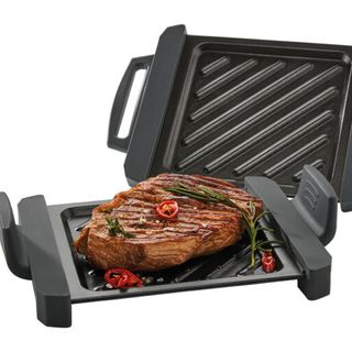 black microwave grill with grilled meat