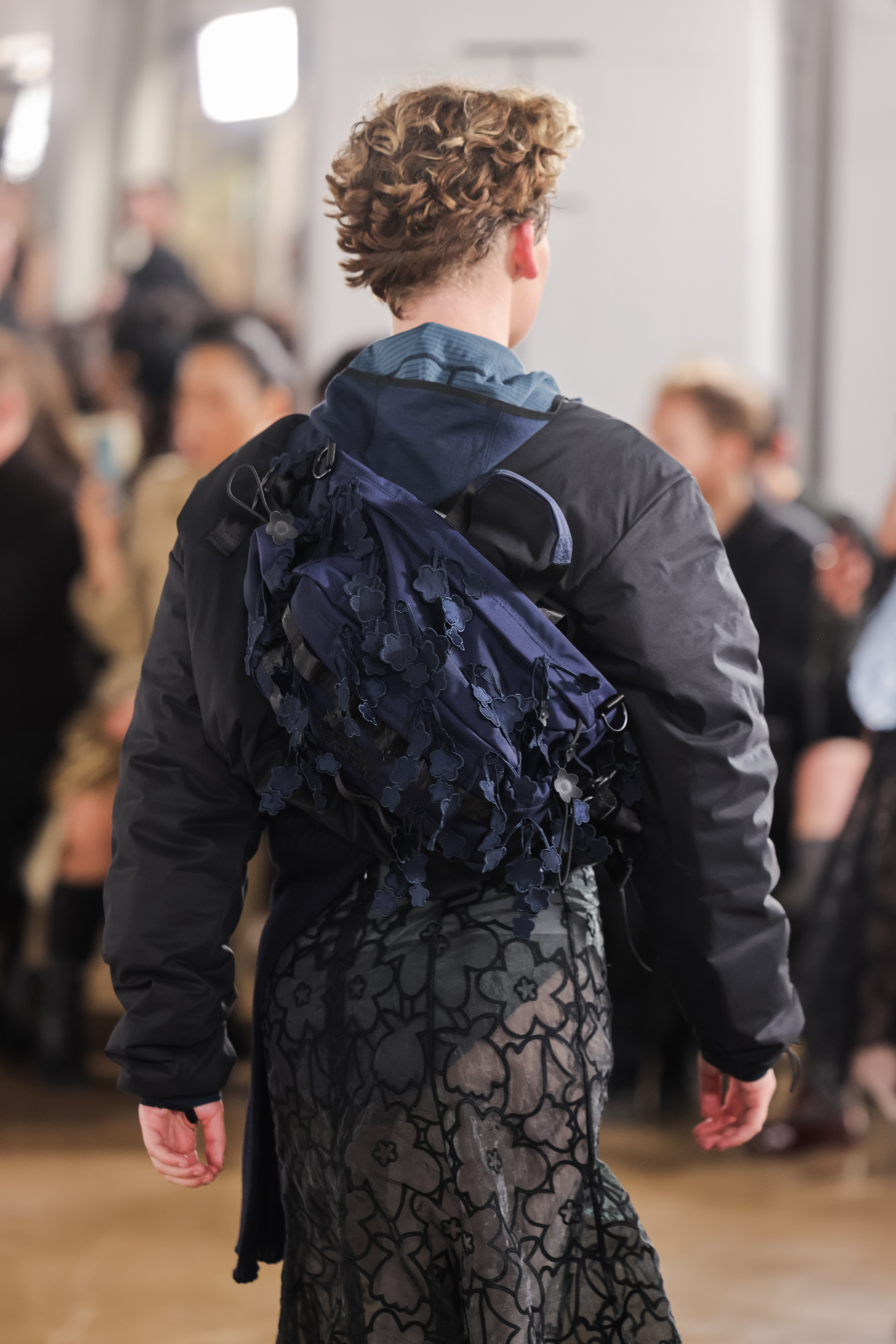 a model on the cecilie bahnsen runway wearing a floral bag from the cecilie north face collection