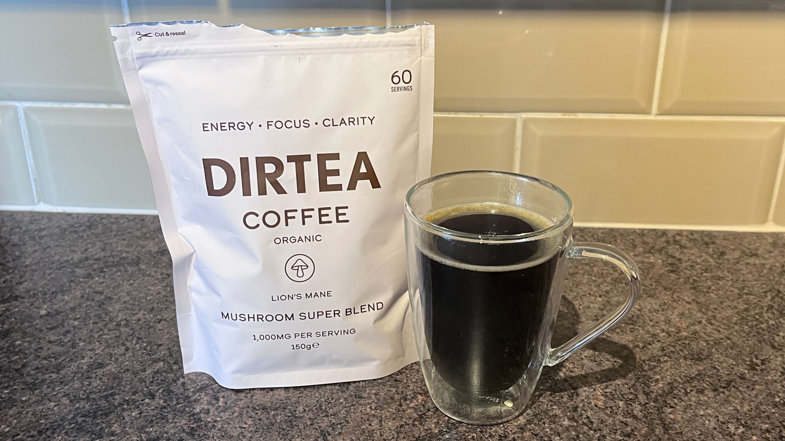 A bag of Dirtea Coffee next to some freshly brewed mushroom coffee