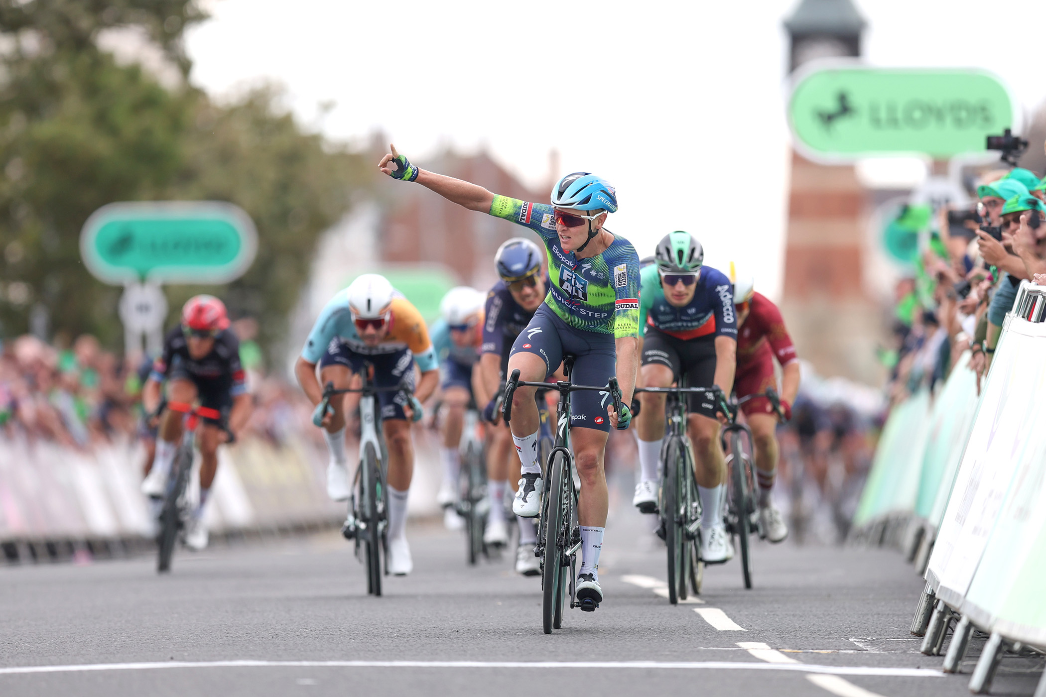 Tim Merlier leads the peloton across the finish line to win on stage 2 of the 2026 Tour of Britain