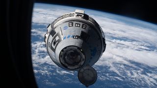 The while Boeing Starliner crew capsule approaches a window on the International Space Station with Earth in the background