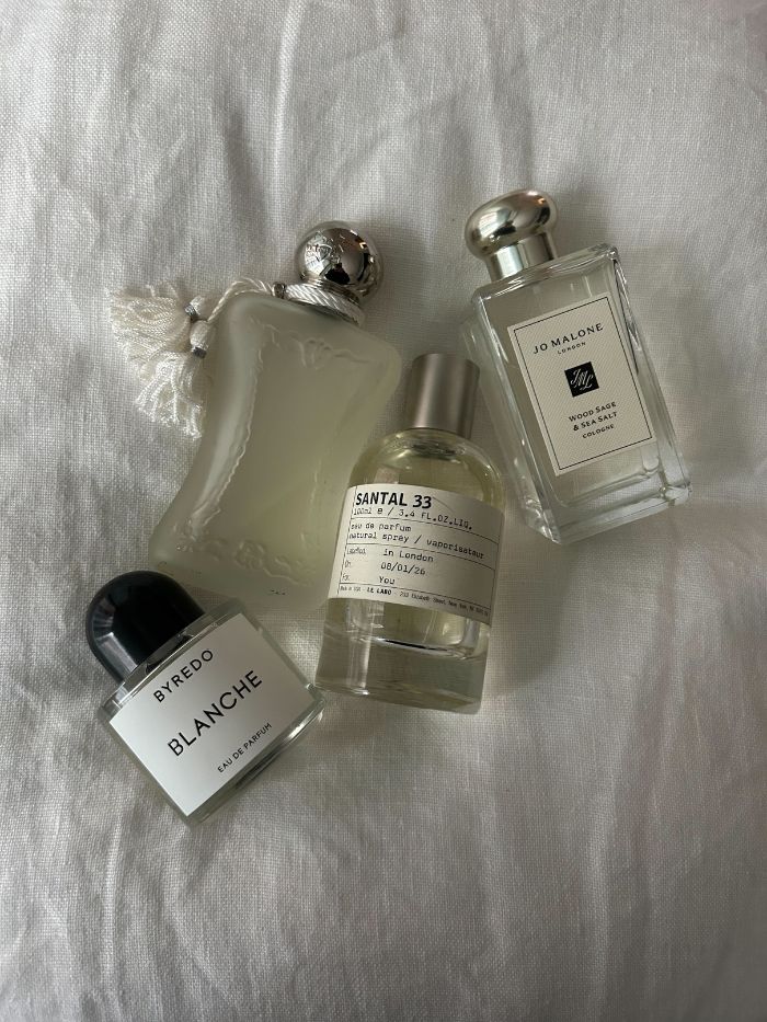 A selection of perfumes from Byredo, Le Labo, Jo Malone and Parfum de Marly on a white linen background