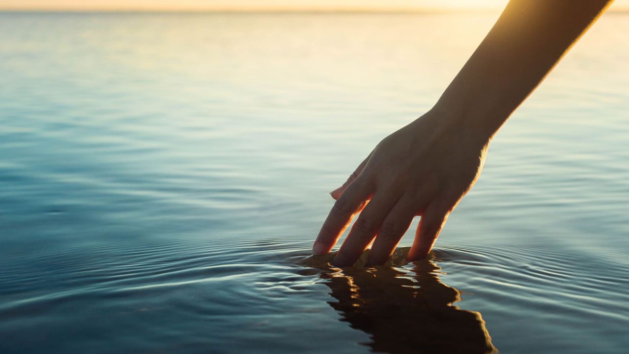 Best toners for dry skin - woman&#039;s hand skimming water