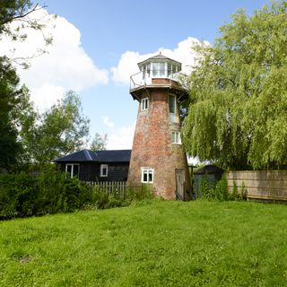 mill house renovation in tower shape with red brick