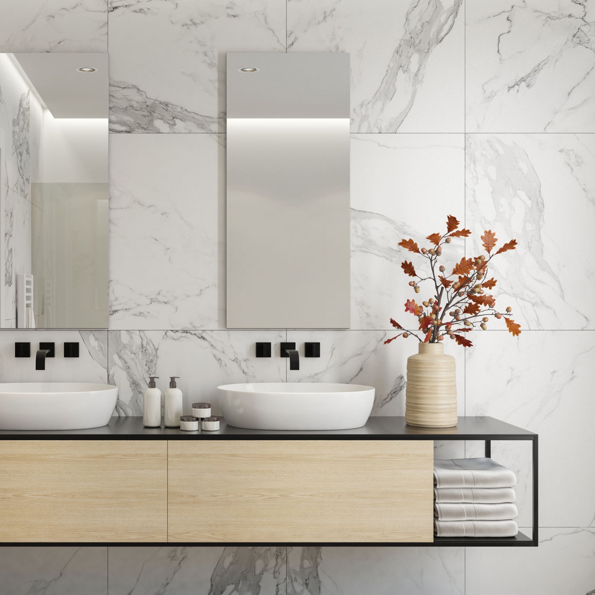 Stone tiles on wall in bathroom with dual sinks, two mirrors and wall-mounted vanity
