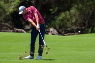 Australian golfer Marc Leishman hits an iron shot