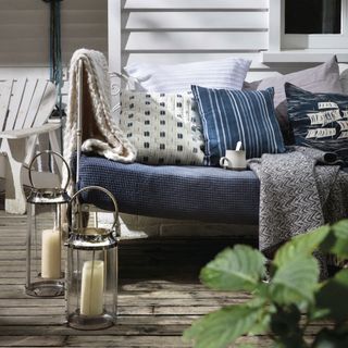 blue sofa with cushions and lanterns