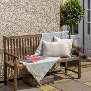wooden bench for outdoor reading with cushions