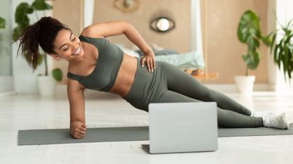 20 minute workouts at home: A woman doing a plank at home