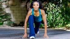 Woman in blue workout kit doing flexibility stretches