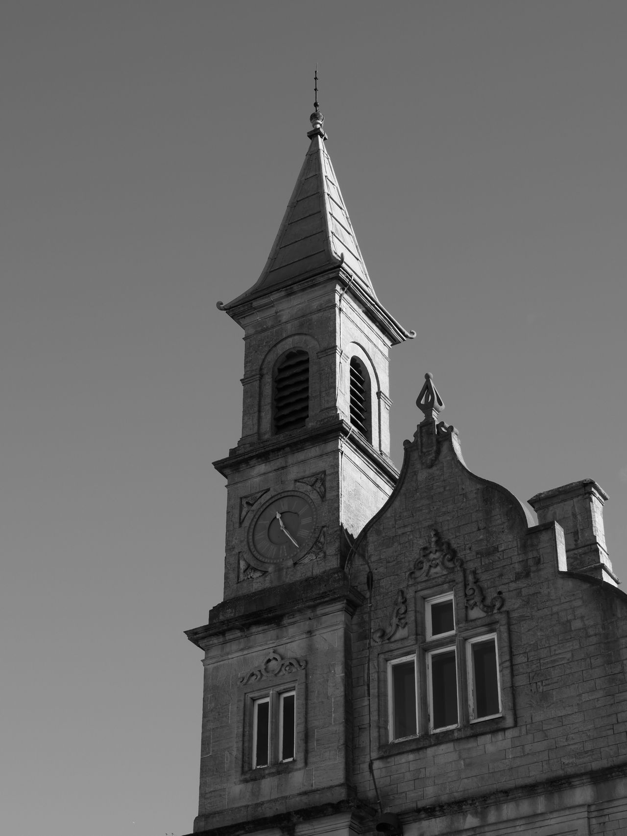 A clock tower photographed in black and white on the Lumix G97