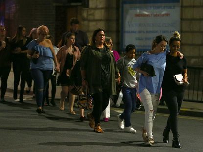 Concertgoers leave the Manchester Arena Monday night.