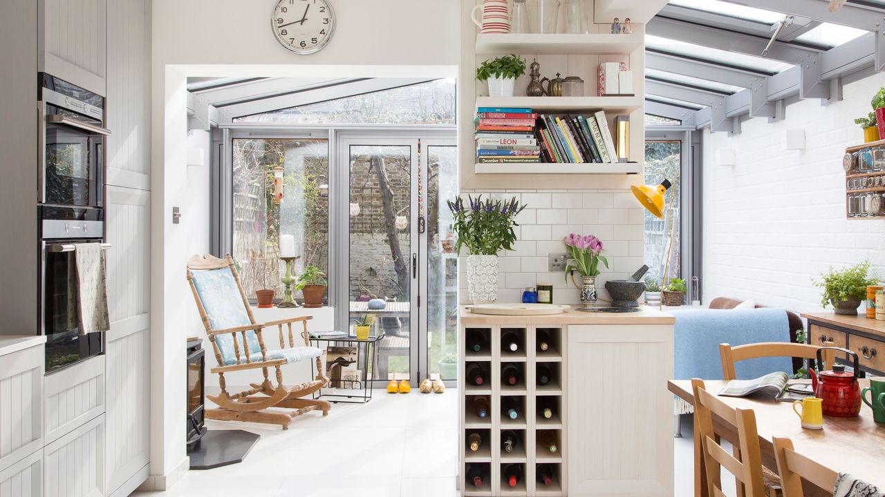 open plan kitchen and dining space with rocking chair and open shelves