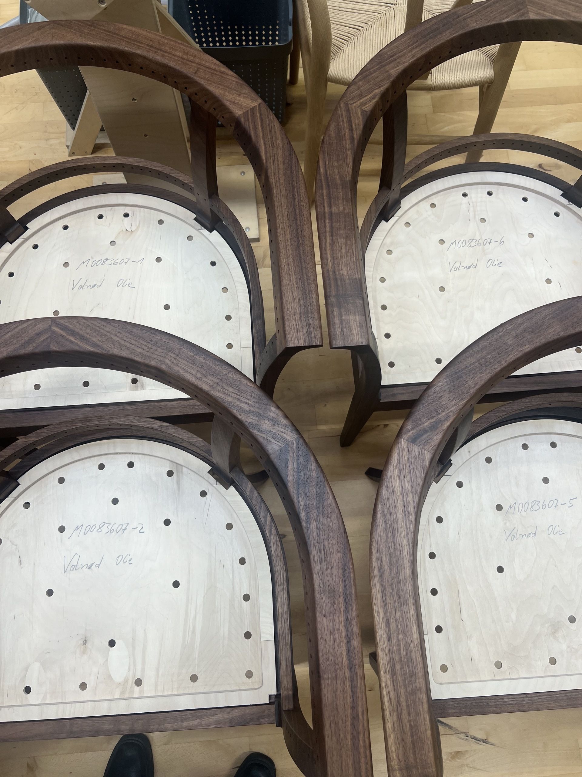 Image from above of four unfinished wooden chairs.
