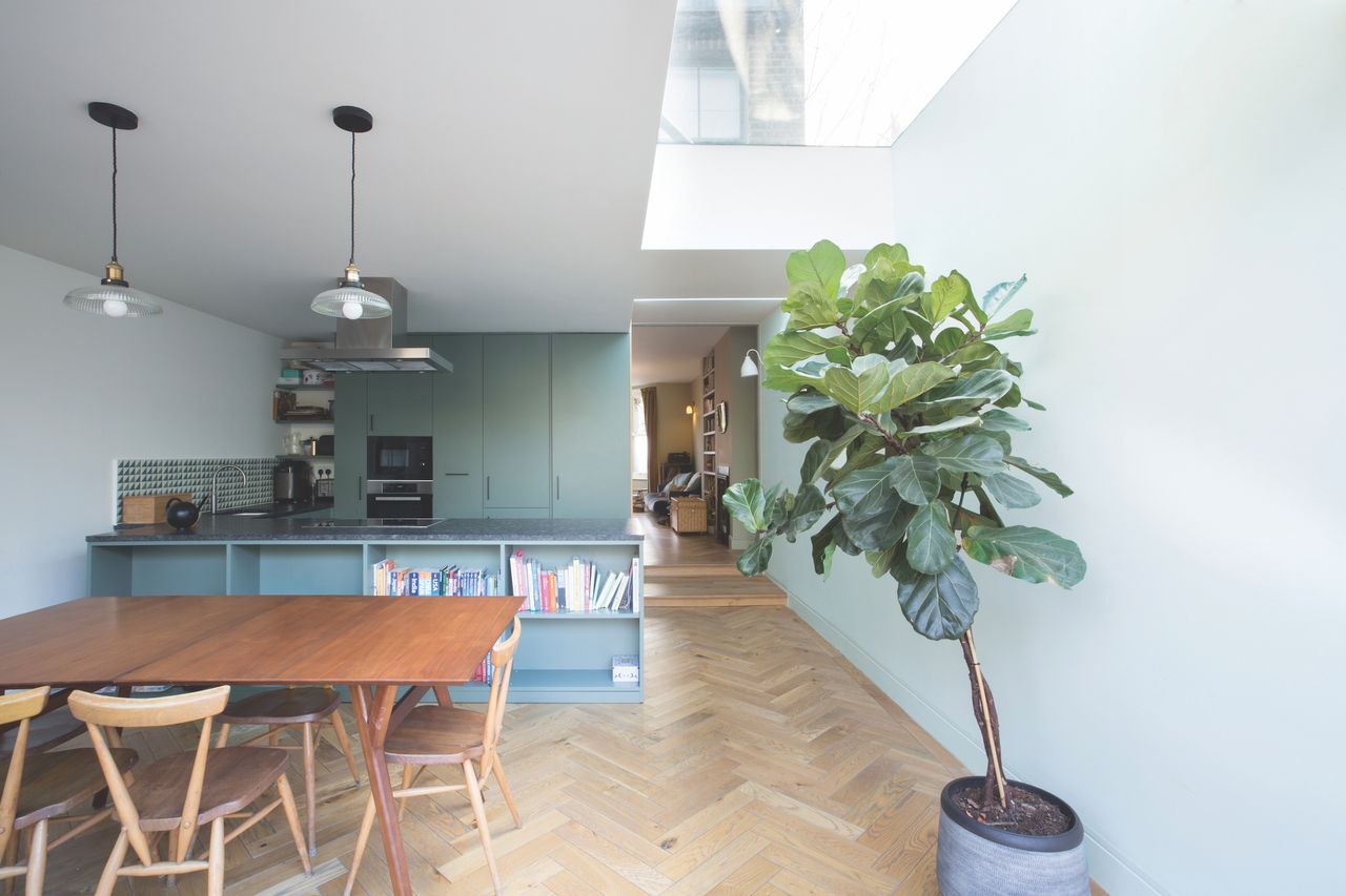 modern blue kitchen with long rooflight