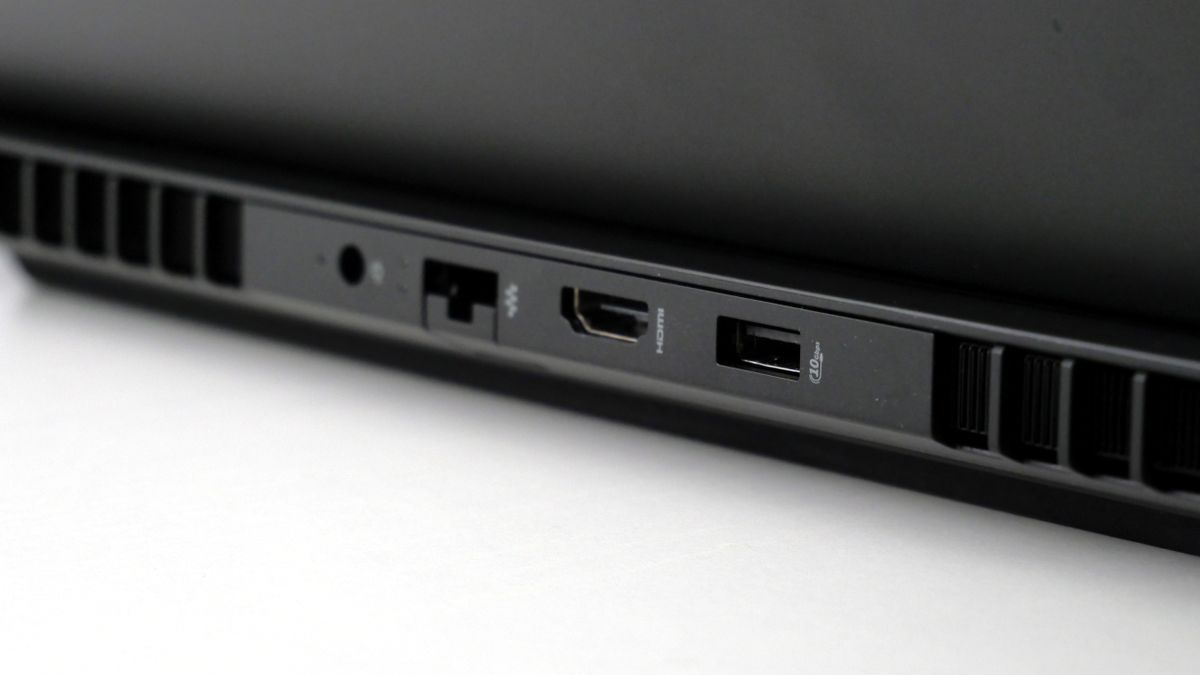 HP Omen Max 16 open on a white desk, highlighting its ports on the back, including one USB Type-A, HDMI, Ethernet, and power jack.