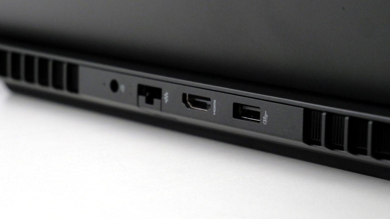 HP Omen Max 16 open on a white desk, highlighting its ports on the back, including one USB Type-A, HDMI, Ethernet, and power jack.