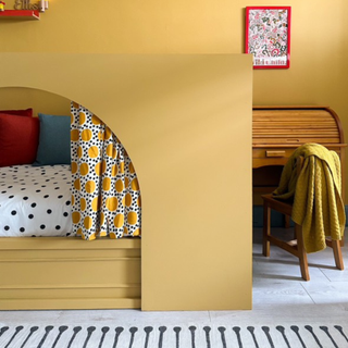 The finished IKEA KURA hack painted in mustard