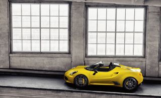 Yellow Alfa Romeo 4C Spider in an industrial space