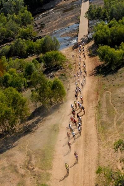 A long straight road and a long bunch of bikers