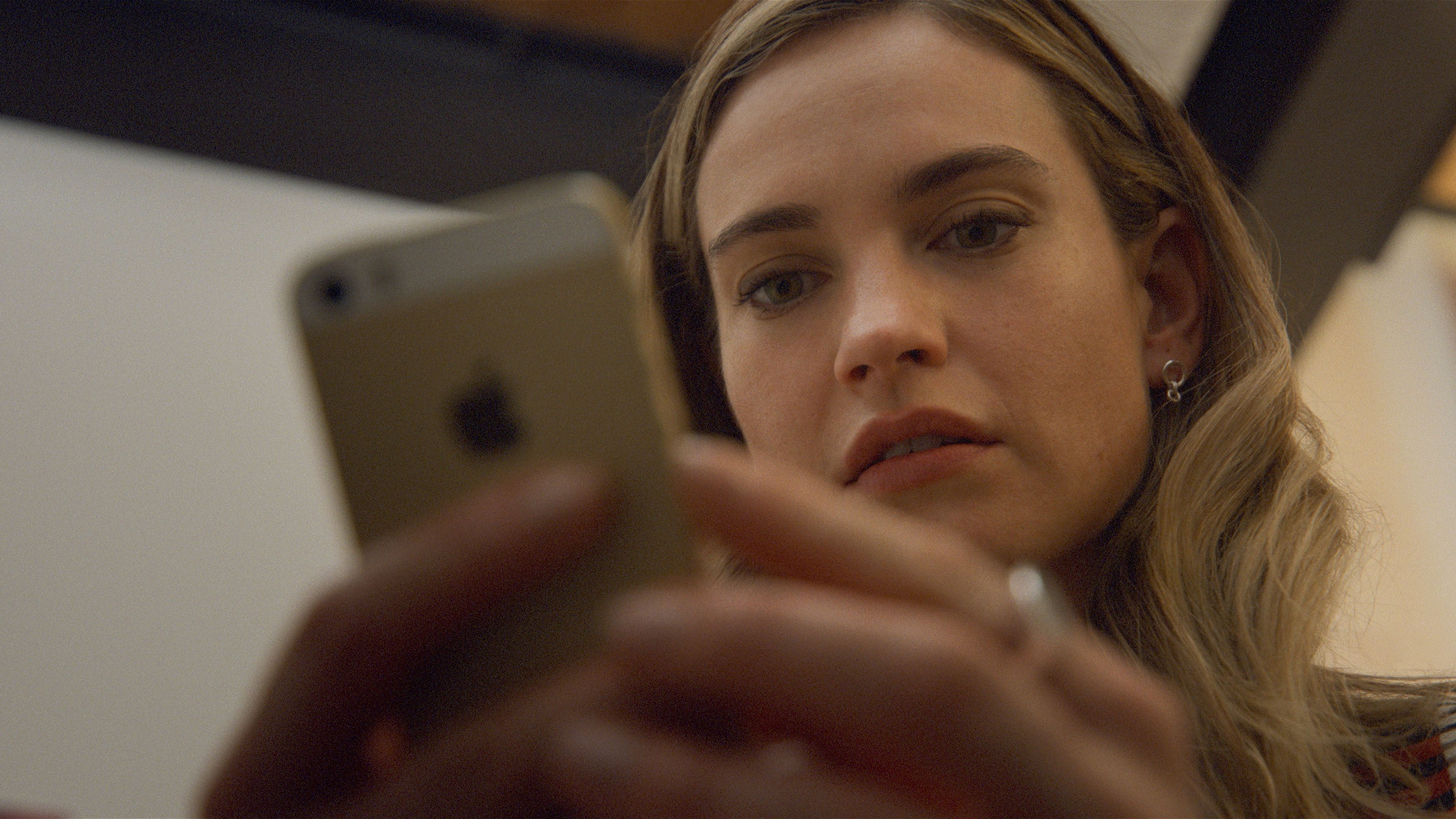 Whitney Wolfe Herd (Lily James) using an iPhone in a scene from "Swiped"