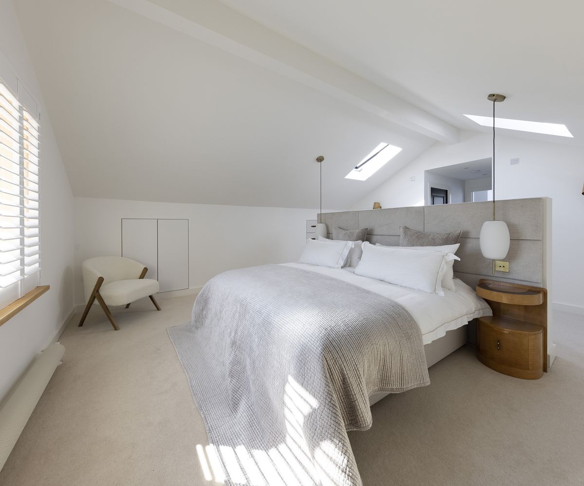 A bed in a pitched roof loft extension on a renovated bungalow