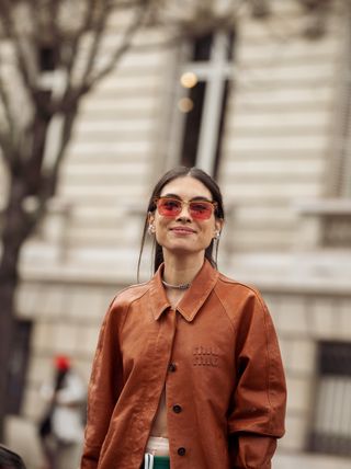 Fer Millan Delaroiere wears green underwear, brown leather shirt and a brown leather bag outside Miu Miu during the Womenswear Fall/Winter 2024/2025 as part of Paris Fashion Week on March 05, 2024 in Paris, France.