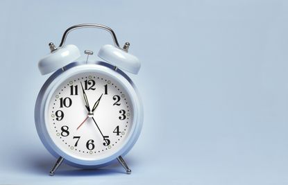 picture of an alarm clock against a light blue background