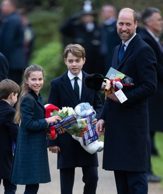 Prince George, Prince Louis, Princess Charlotte, and Prince William carry gifts from royal fans at Sandringham on Christmas Day