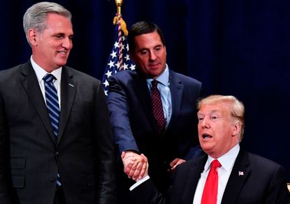 Trump shakes hands with Rep. Devin Nunes, with Rep. Kevin McCarthy looking on
