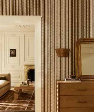 grasscloth striped wallpaper in a neutral and toffee colored living room