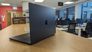 MacBook Pro 16-inch with screen open in an office