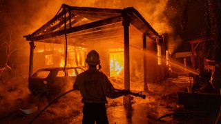 Firefighters battle the Eaton Fire on January 8, 2025 in Altadena, California.