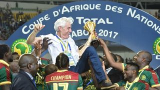 Hugo Broos surrounded by Cameroon players at AFCON 2017