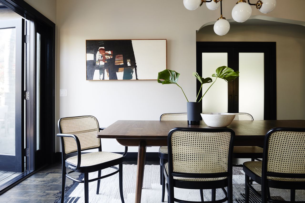 Brown dining table with black cane dining chairs