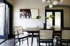 Brown dining table with black cane dining chairs