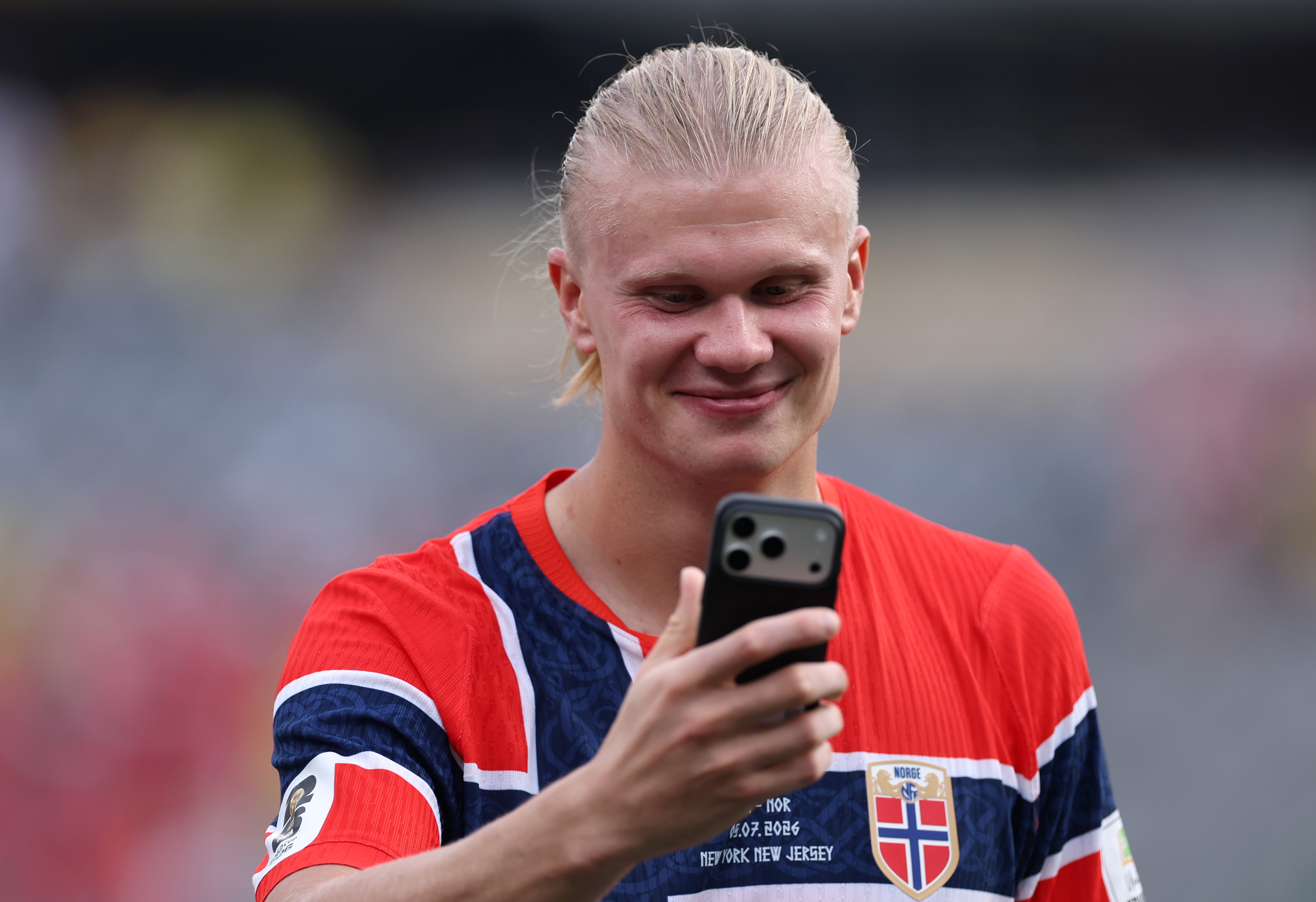 Erling Haaland speaks on a phone after winning the FIFA World Cup 2026 Round Of 16 match between Brazil and Norway. (Photo by Justin Setterfield/Getty Images)