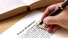 A man fills out power of attorney paperwork.